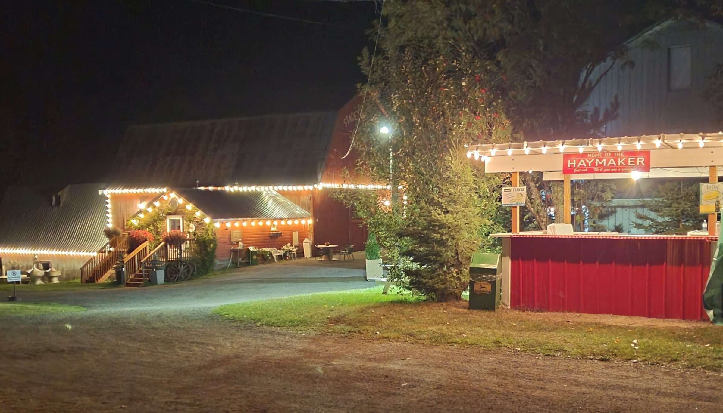 The barns and Haymaker stand illuminated at night